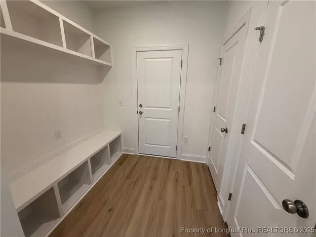 a view of room with wooden floor and staircase