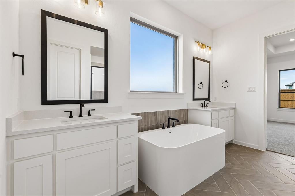 15852 Amber Street Frisco, TX 75033 - Photo 9 of 19 a bathroom with 2 sink and a mirror