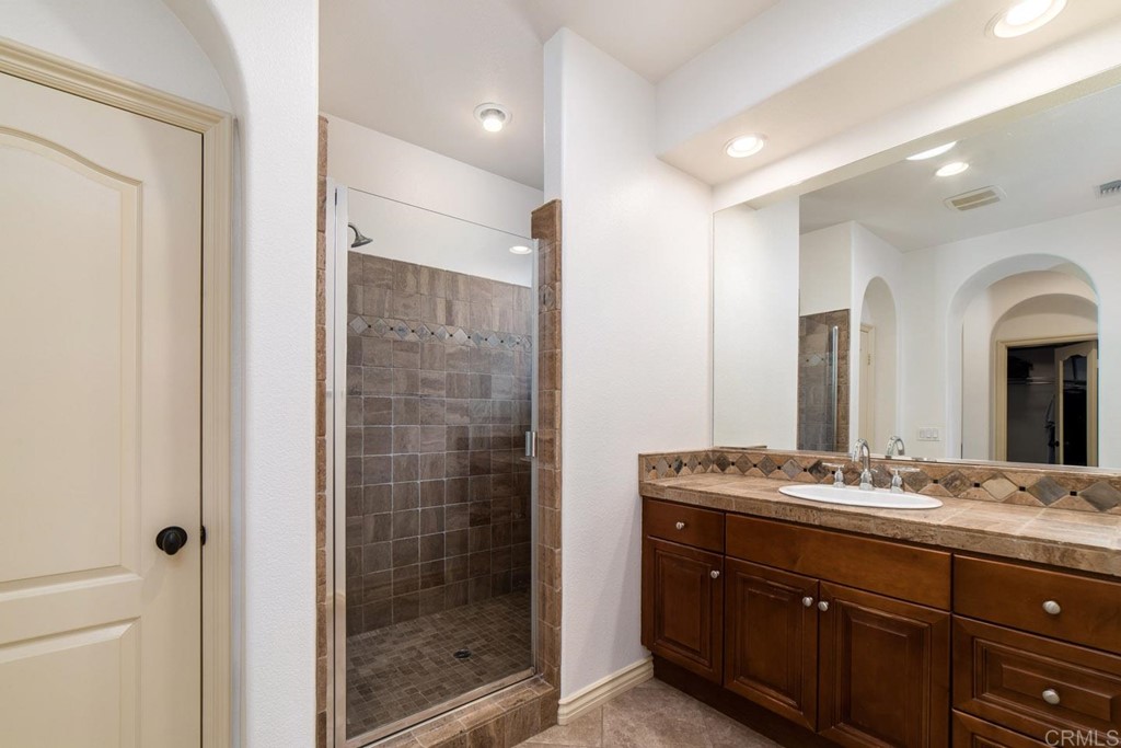 6237 Paseo Privado Carlsbad, CA 92009 - Photo 11 of 29 a bathroom with a granite countertop sink mirror and double