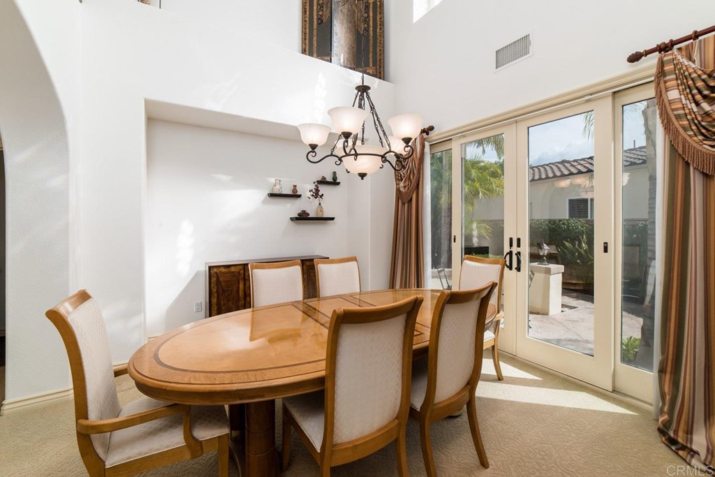 6237 Paseo Privado Carlsbad, CA 92009 - Photo 16 of 29 a view of a dining room with furniture and a chandelier