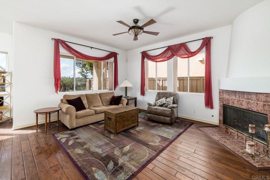 6237 Paseo Privado Carlsbad, CA 92009 - Photo 18 of 29 a living room with furniture ceiling fan and a fireplace