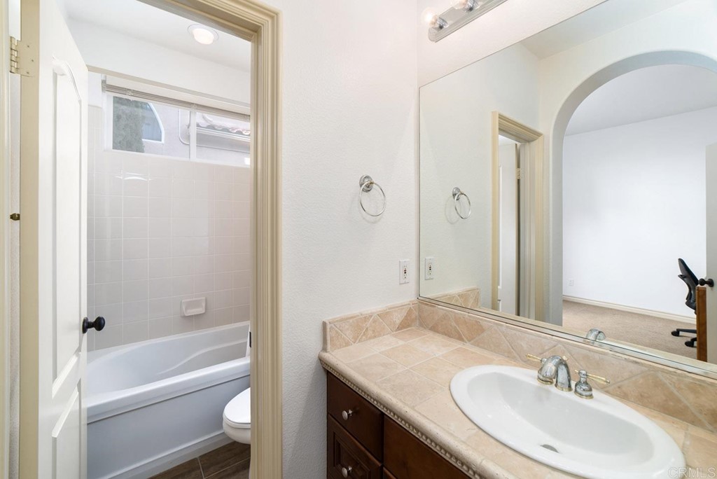 6237 Paseo Privado Carlsbad, CA 92009 - Photo 26 of 29 a bathroom with a granite countertop sink toilet and shower