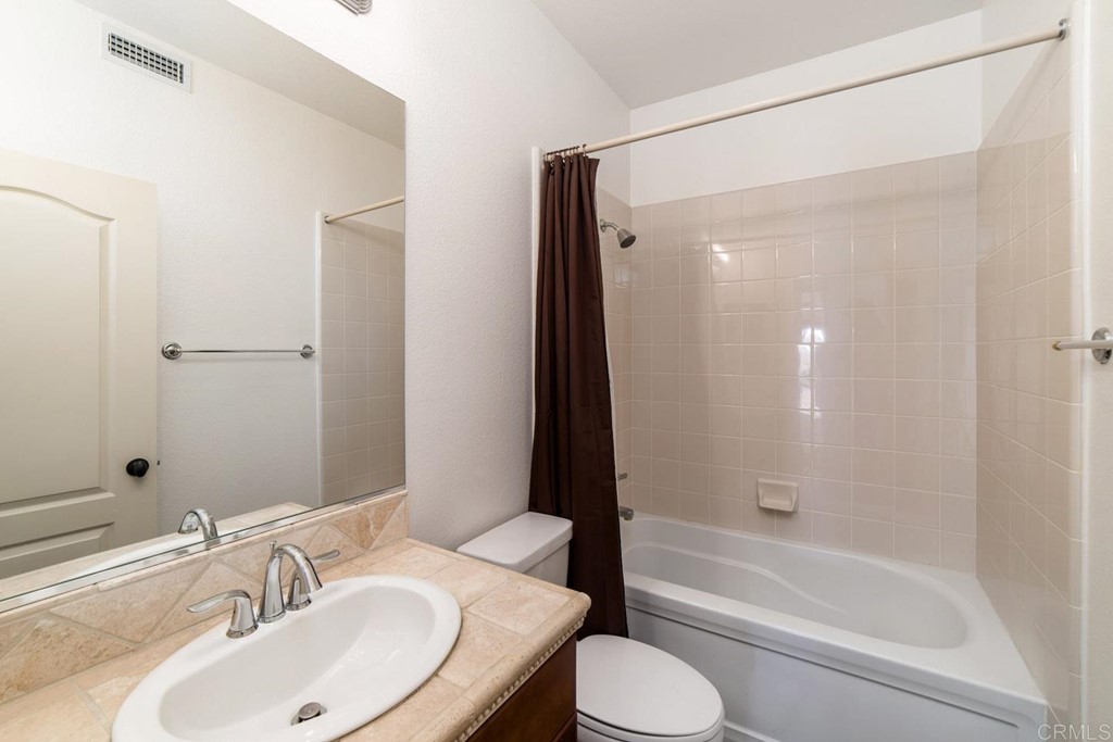 6237 Paseo Privado Carlsbad, CA 92009 - Photo 27 of 29 a bathroom with a sink toilet and shower