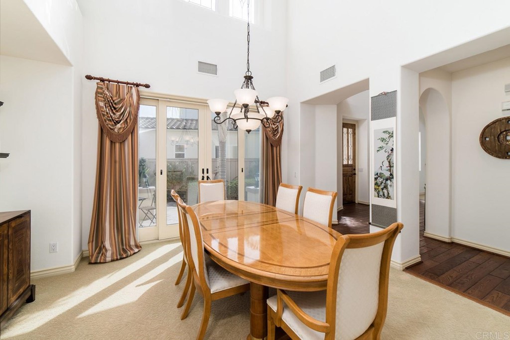 6237 Paseo Privado Carlsbad, CA 92009 - Photo 6 of 29 a view of a dining room with furniture and chandelier