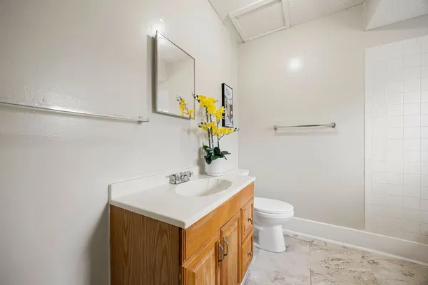 a bathroom with a sink mirror vanity and toilet
