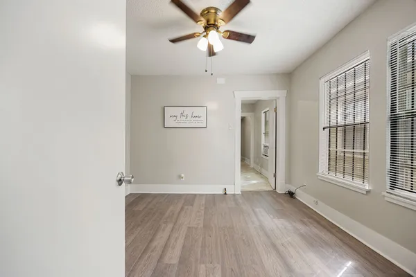 wooden floor in an empty room with a window