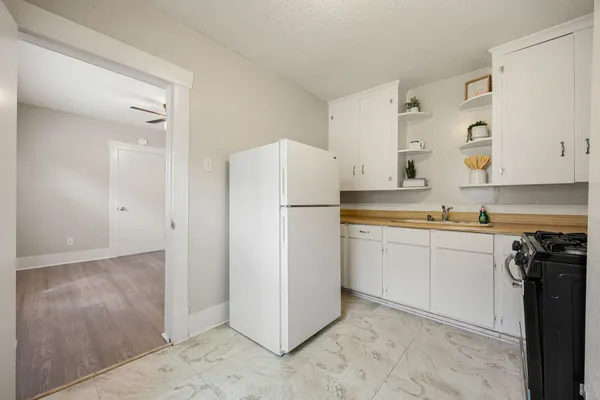 a kitchen with a refrigerator and a sink