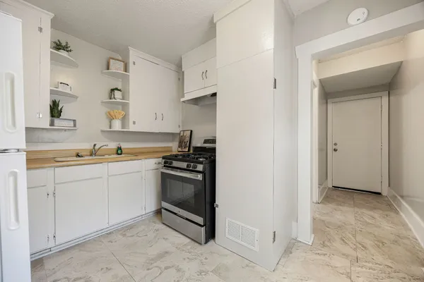 a kitchen with stainless steel appliances granite countertop a sink and a stove