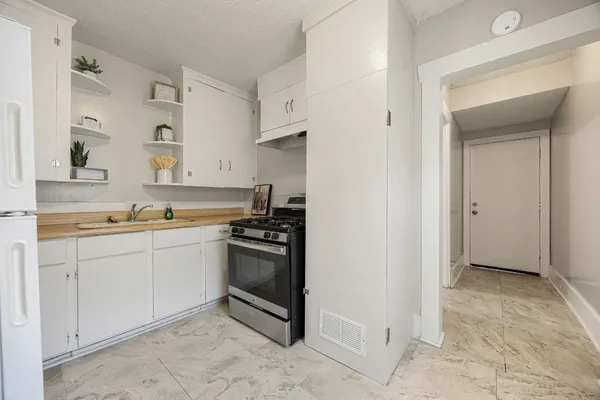 a kitchen with stainless steel appliances granite countertop a sink and a stove