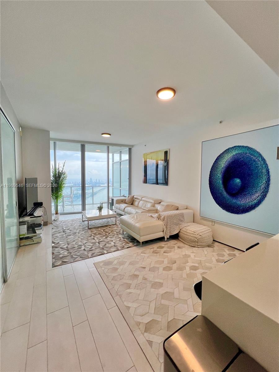 1100 Biscayne Boulevard, Unit 5804 Miami, FL 33132 - Photo 2 of 6 a bedroom with a large bed and large windows