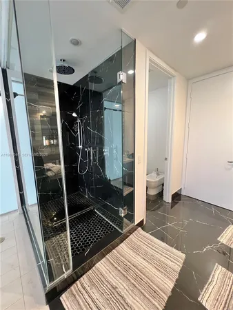 a bathroom with a glass shower door