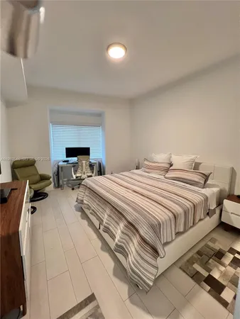 a bedroom with a bed and a lamp
