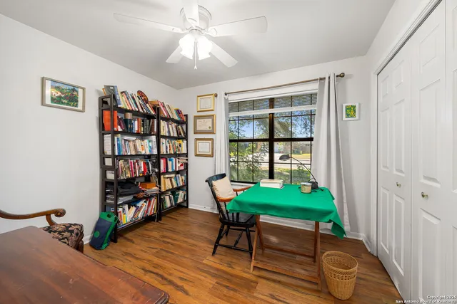 a living room with furniture and a bookshelf
