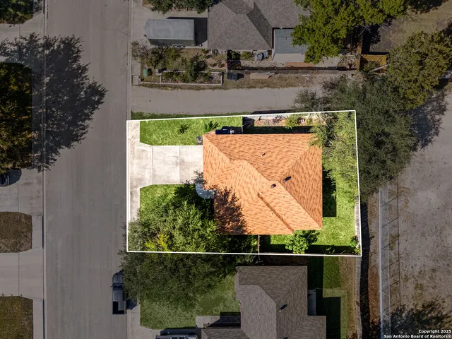 an aerial view of residential houses with outdoor space