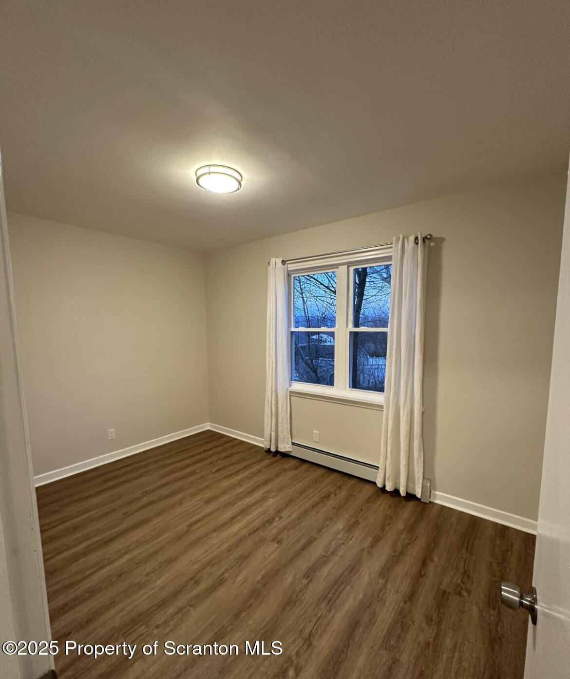 2008 South Webster Avenue Scranton, PA 18505 - Photo 9 of 10 an empty room with wooden floor and windows