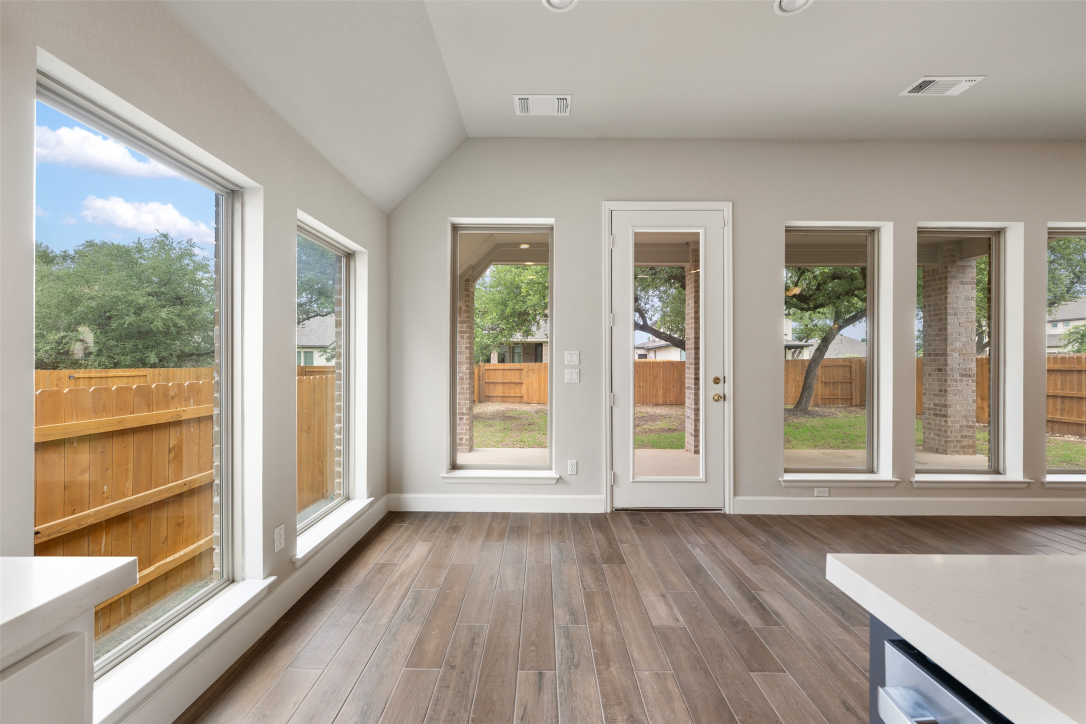 104 Anejo Bluff Georgetown, TX 78628 - Photo 23 of 40 a view of an empty room with wooden floor and windows