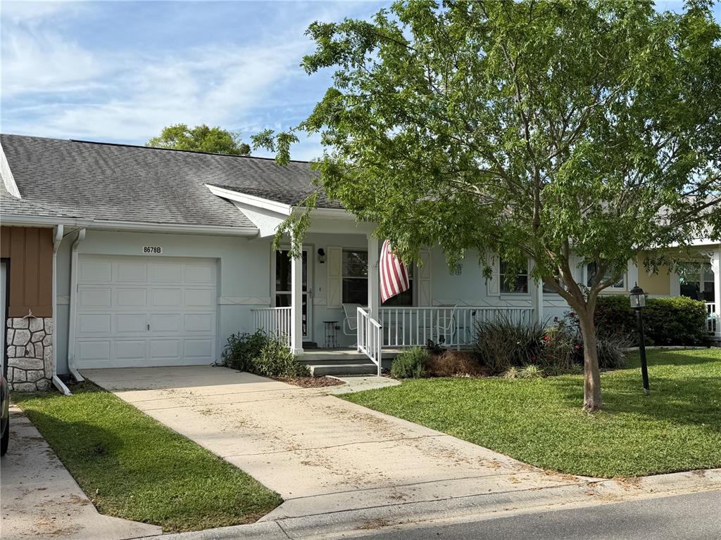 8678 Southwest 95 Street, Unit B Ocala, FL 34481 - Photo 1 of 22 a front view of a house with a garden