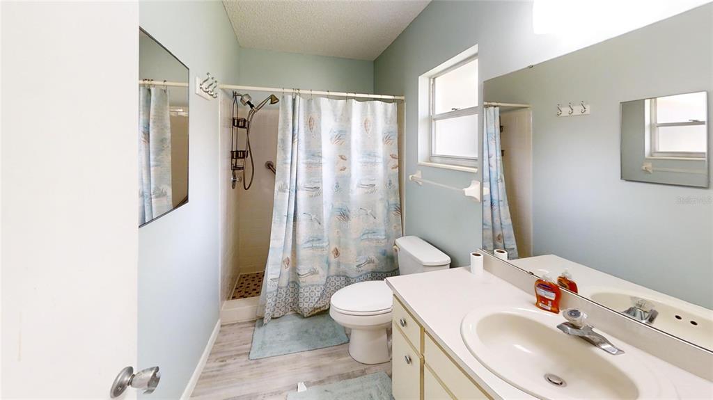 8678 Southwest 95 Street, Unit B Ocala, FL 34481 - Photo 18 of 22 a bathroom with a sink toilet and shower