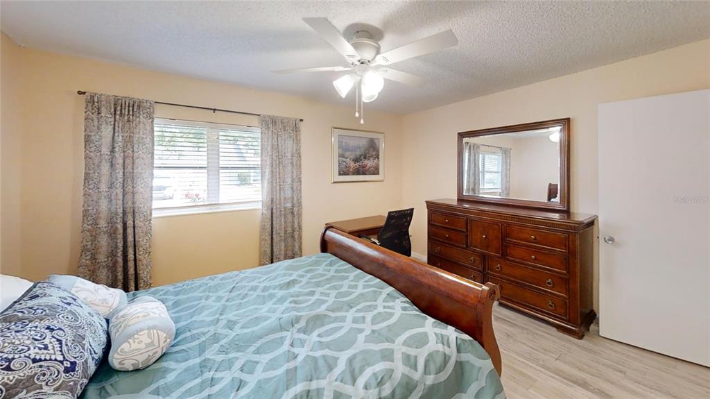 8678 Southwest 95 Street, Unit B Ocala, FL 34481 - Photo 20 of 22 a bedroom with a bed and a dresser