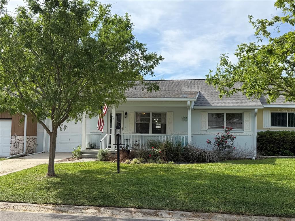8678 Southwest 95 Street, Unit B Ocala, FL 34481 - Photo 2 of 22 a view of a house with a yard and plants