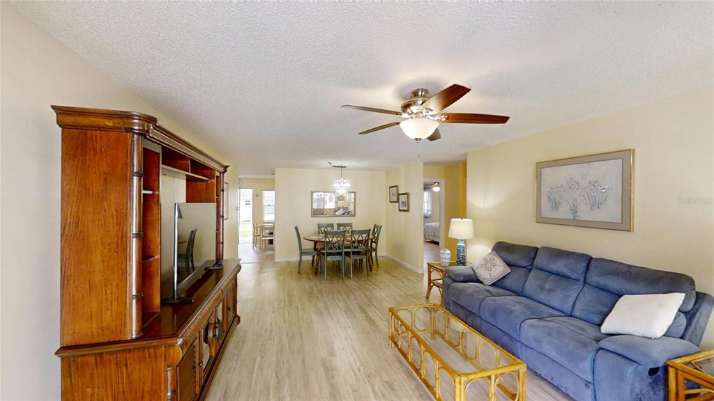 8678 Southwest 95 Street, Unit B Ocala, FL 34481 - Photo 3 of 22 a living room with furniture ceiling fan and a wooden floor