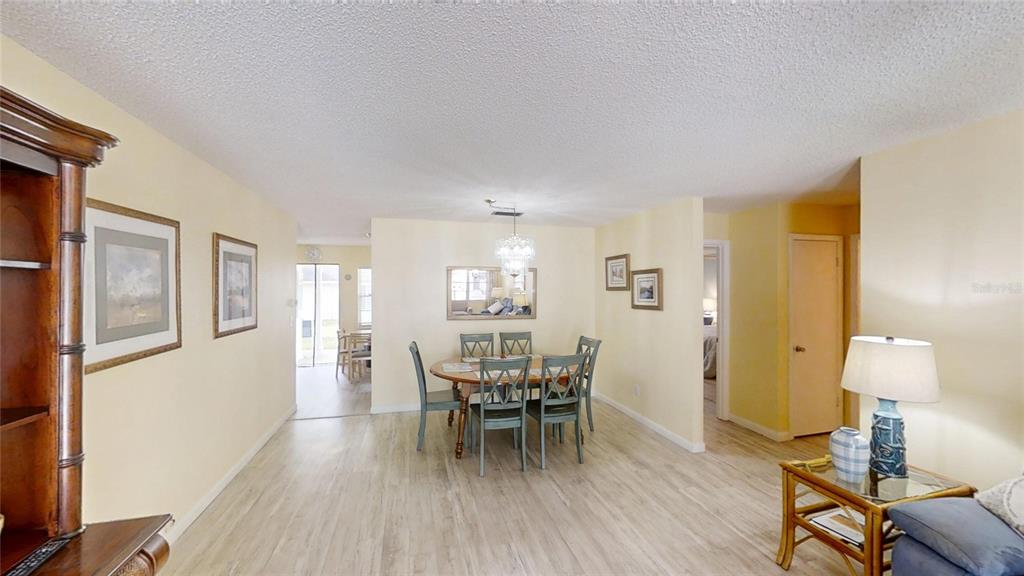8678 Southwest 95 Street, Unit B Ocala, FL 34481 - Photo 4 of 22 a view of a dining room with furniture and wooden floor