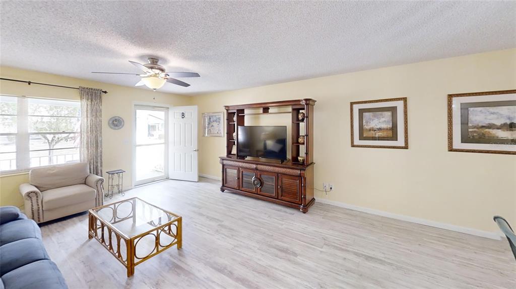 8678 Southwest 95 Street, Unit B Ocala, FL 34481 - Photo 5 of 22 a living room with furniture and a flat screen tv