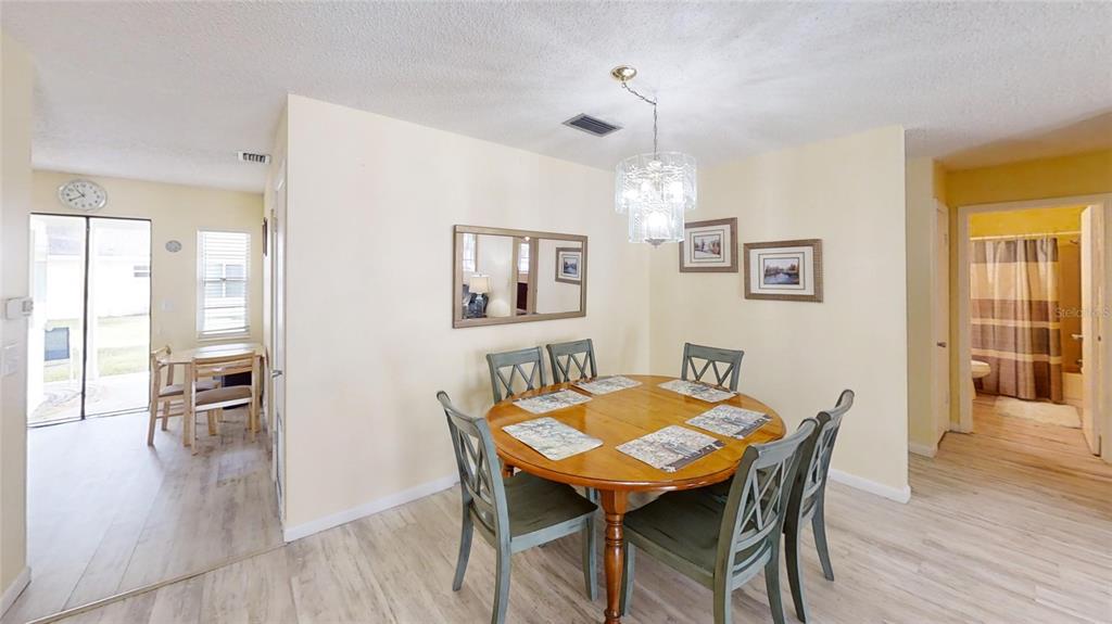 8678 Southwest 95 Street, Unit B Ocala, FL 34481 - Photo 7 of 22 a view of a dining room with furniture and wooden floor