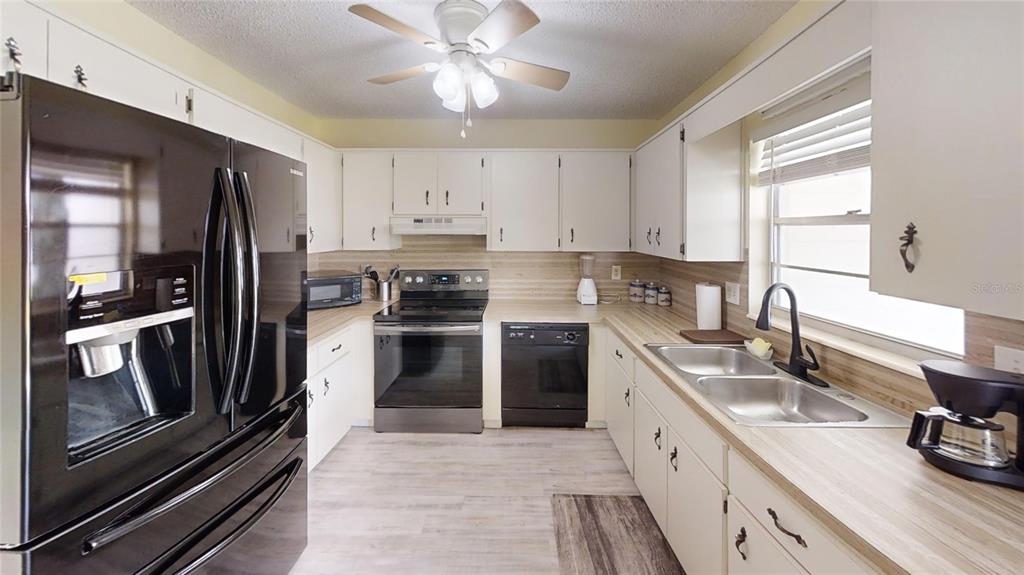 8678 Southwest 95 Street, Unit B Ocala, FL 34481 - Photo 9 of 22 a kitchen with a refrigerator stove and sink