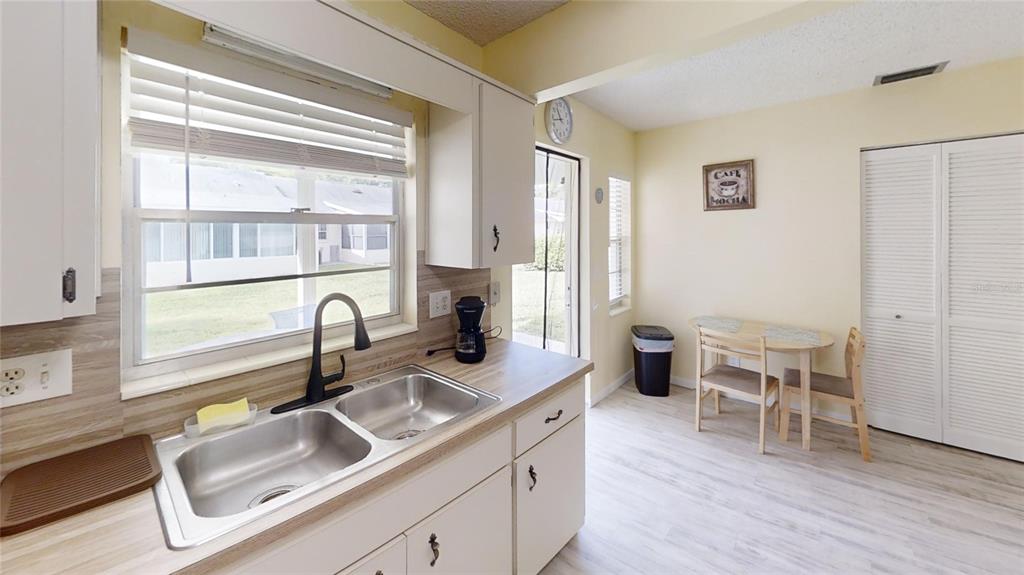 8678 Southwest 95 Street, Unit B Ocala, FL 34481 - Photo 10 of 22 a kitchen with a sink and wooden cabinets