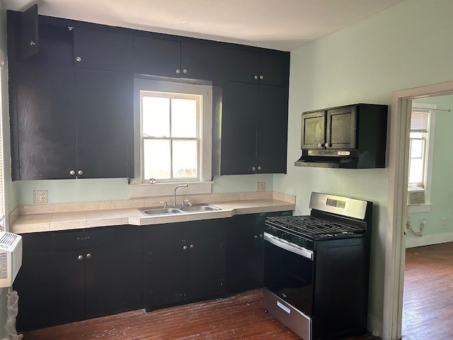 4725 Avenue R 1/2 Galveston, TX 77551 - Photo 2 of 18 a kitchen with a sink and a stove
