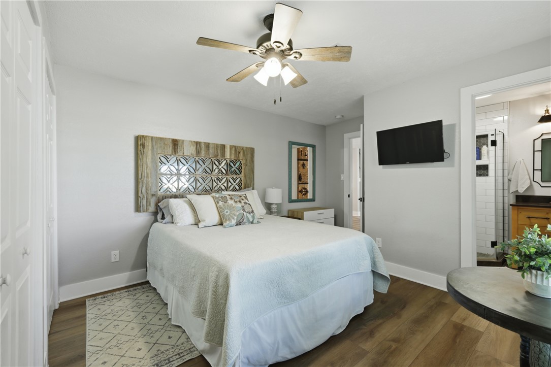 515 Crescent Drive Bryan, TX 77801 - Photo 29 of 43 Bedroom featuring wood-finish flooring, a ceiling fan, and a wall-mounted television