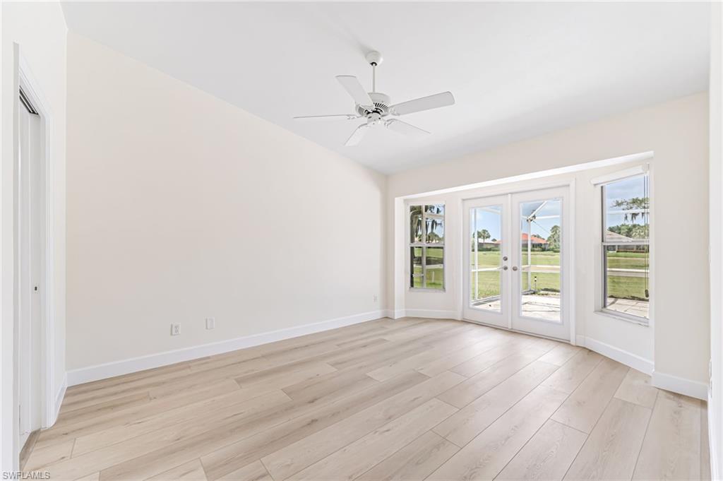 8562 Mustang Drive, Unit 31 Naples, FL 34113 - Photo 12 of 44 Unfurnished room with baseboards, a ceiling fan, french doors, and light wood-style floors