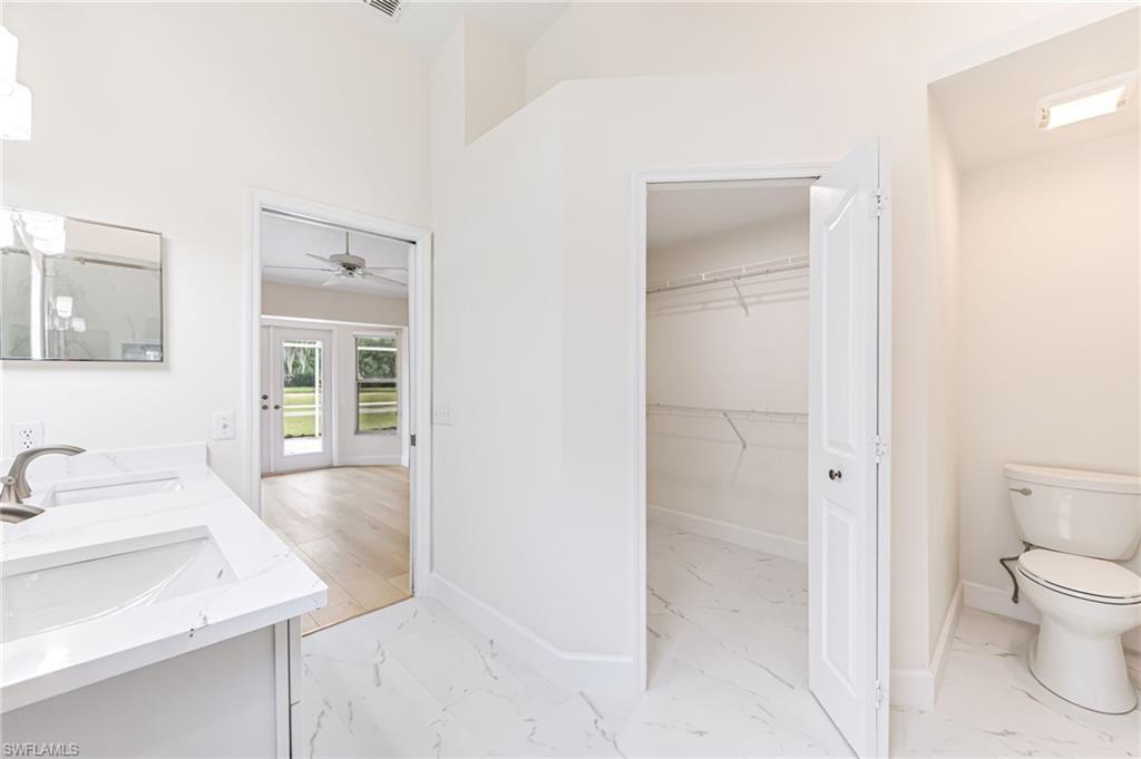 8562 Mustang Drive, Unit 31 Naples, FL 34113 - Photo 17 of 44 Bathroom featuring marble finish floor, baseboards, ceiling fan, and toilet