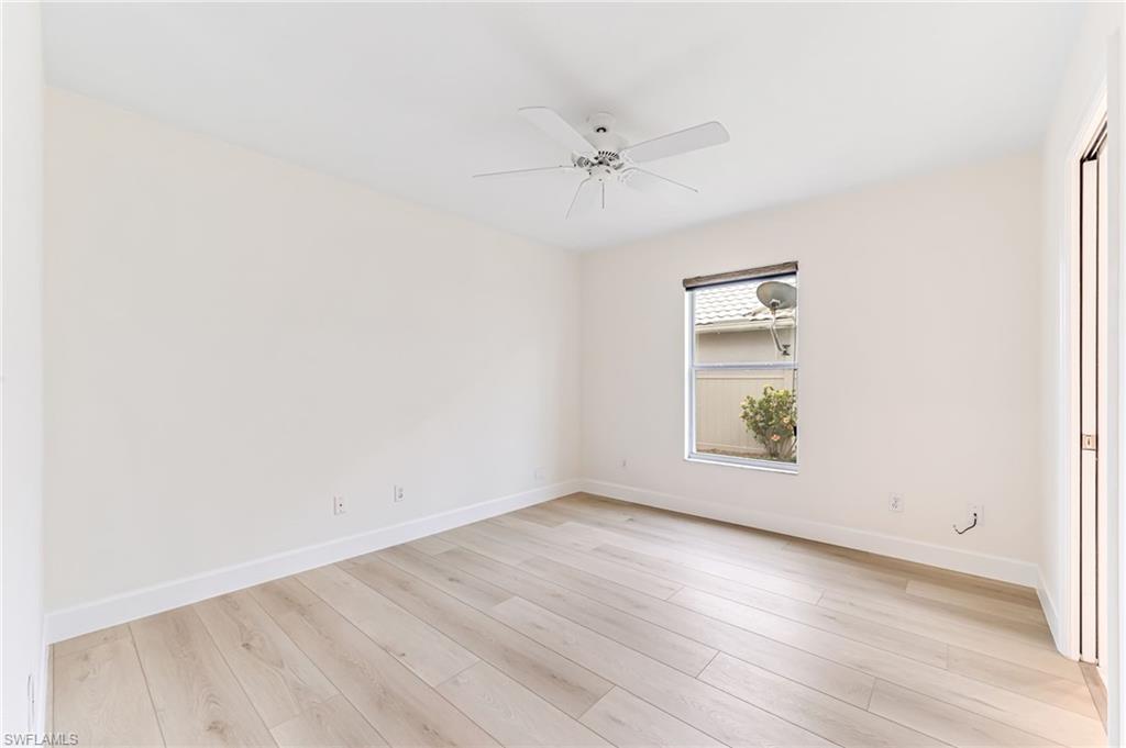 8562 Mustang Drive, Unit 31 Naples, FL 34113 - Photo 18 of 44 Spare room featuring light wood-style flooring, baseboards, and ceiling fan