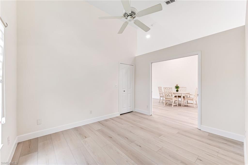8562 Mustang Drive, Unit 31 Naples, FL 34113 - Photo 24 of 44 Unfurnished room featuring visible vents, a ceiling fan, light wood-type flooring, baseboards, and high vaulted ceiling