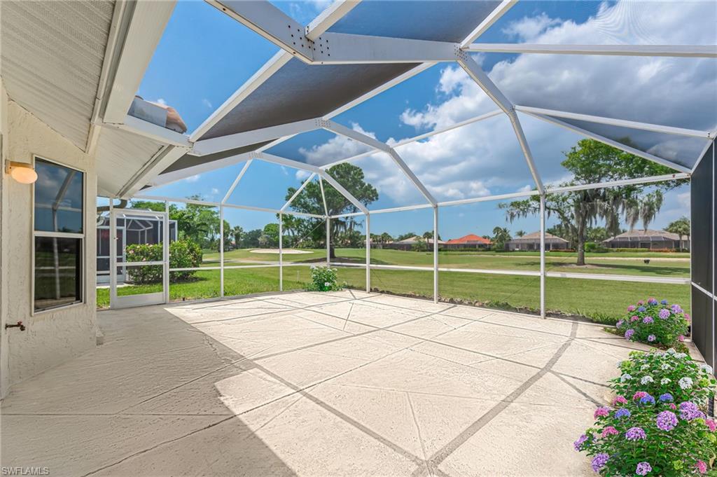 8562 Mustang Drive, Unit 31 Naples, FL 34113 - Photo 26 of 44 View of patio / terrace featuring glass enclosure