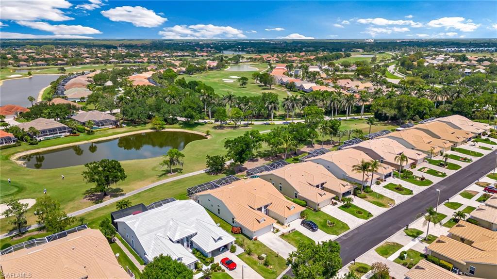 8562 Mustang Drive, Unit 31 Naples, FL 34113 - Photo 29 of 44 Birds eye view of property featuring golf course view, a residential view, and a water view