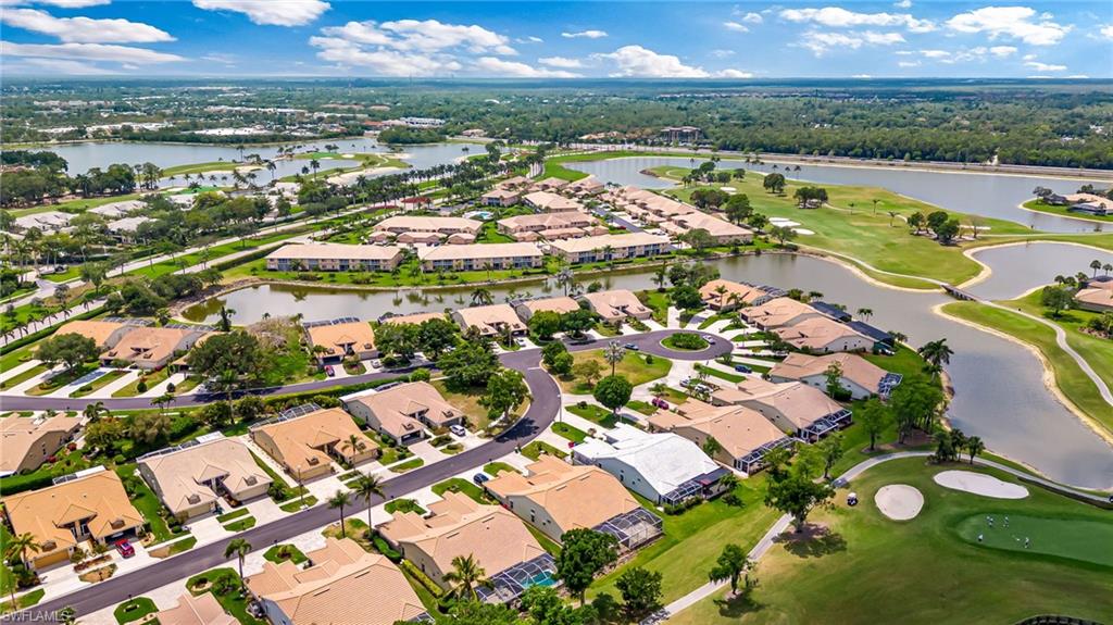 8562 Mustang Drive, Unit 31 Naples, FL 34113 - Photo 37 of 44 Birds eye view of property with a water view, a residential view, and golf course view