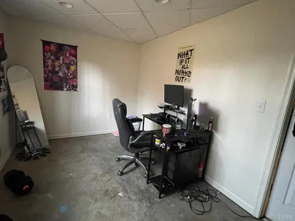 a view of a workspace with furniture and a window