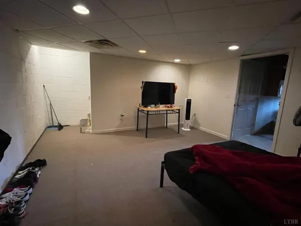 a bedroom with a bed furniture and a flat screen tv