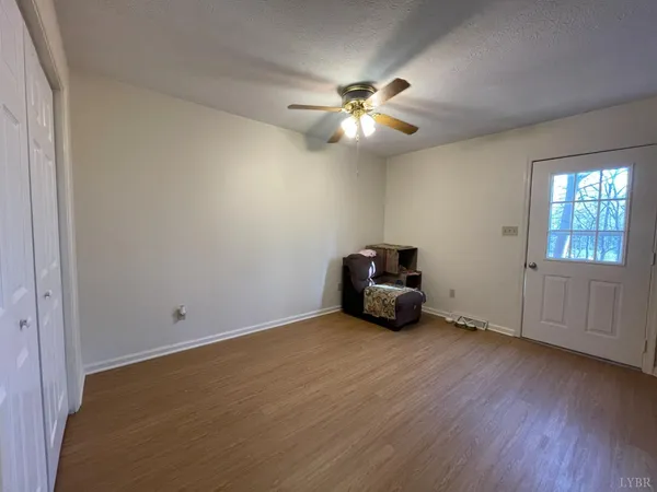 a view of room with hardwood floor and ceiling fan