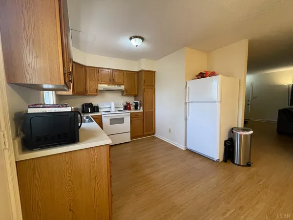 a kitchen with a refrigerator sink and cabinets