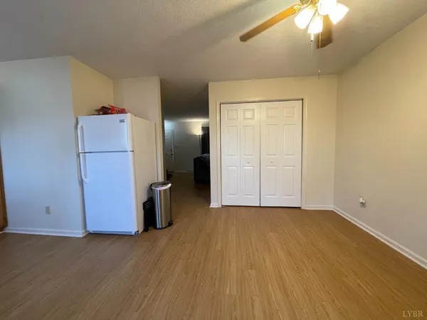 a view of an empty room with a kitchen