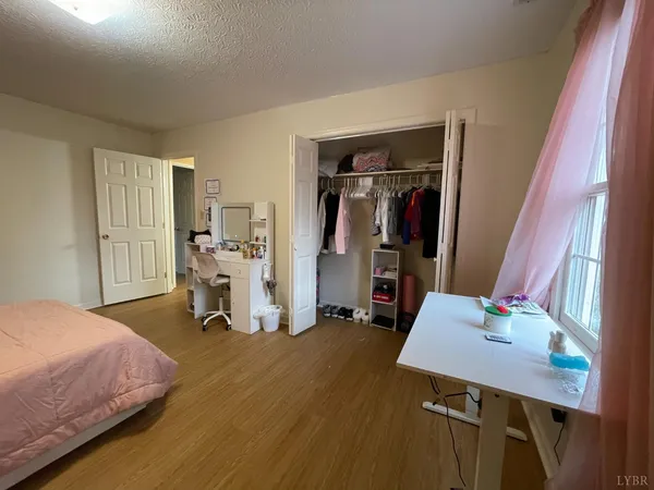 a bedroom with a bed and a desk