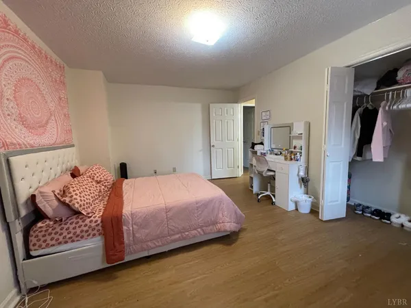 a bedroom with a bed and a couch