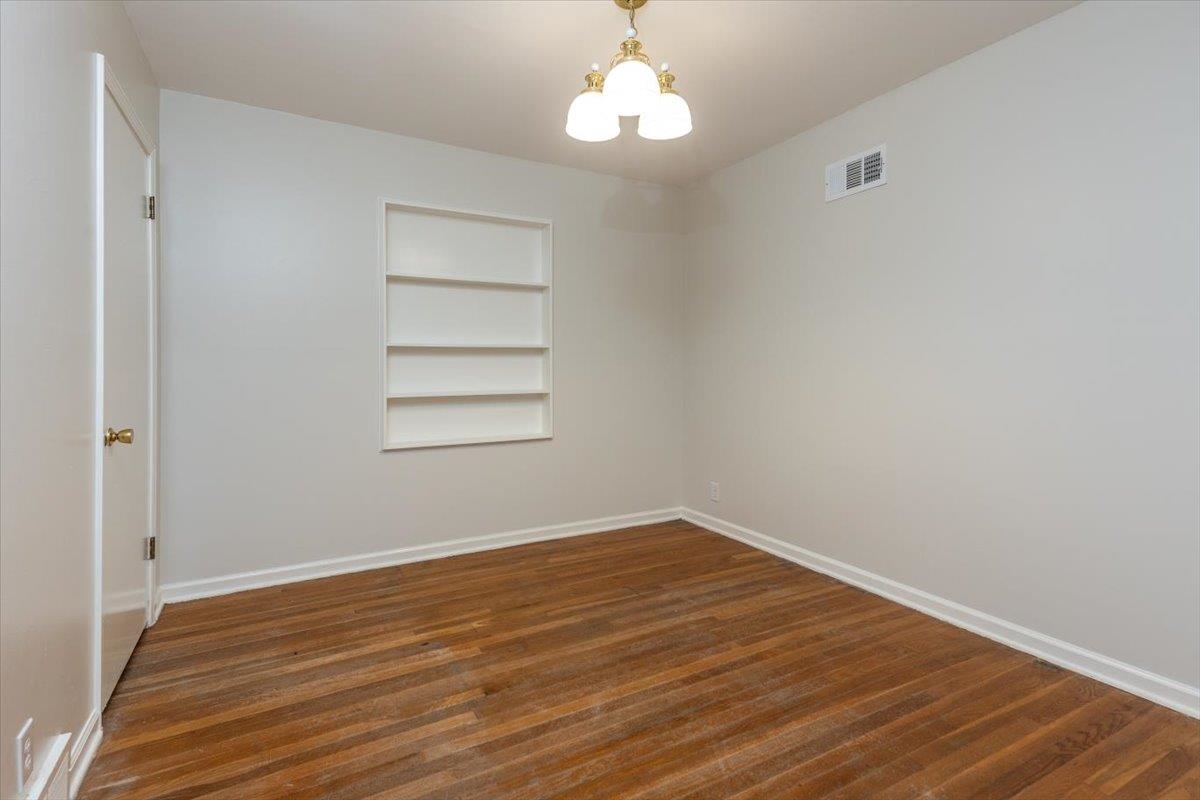670 Peterson Lake Road Collierville, TN 38017 - Photo 21 of 37 Bright interior space featuring wood-finish flooring, white baseboards, and a built-in recessed shelving unit