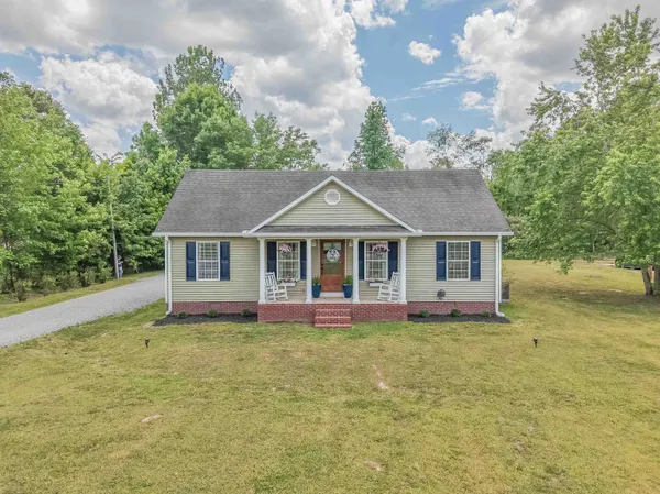 a view of house with a backyard and deck