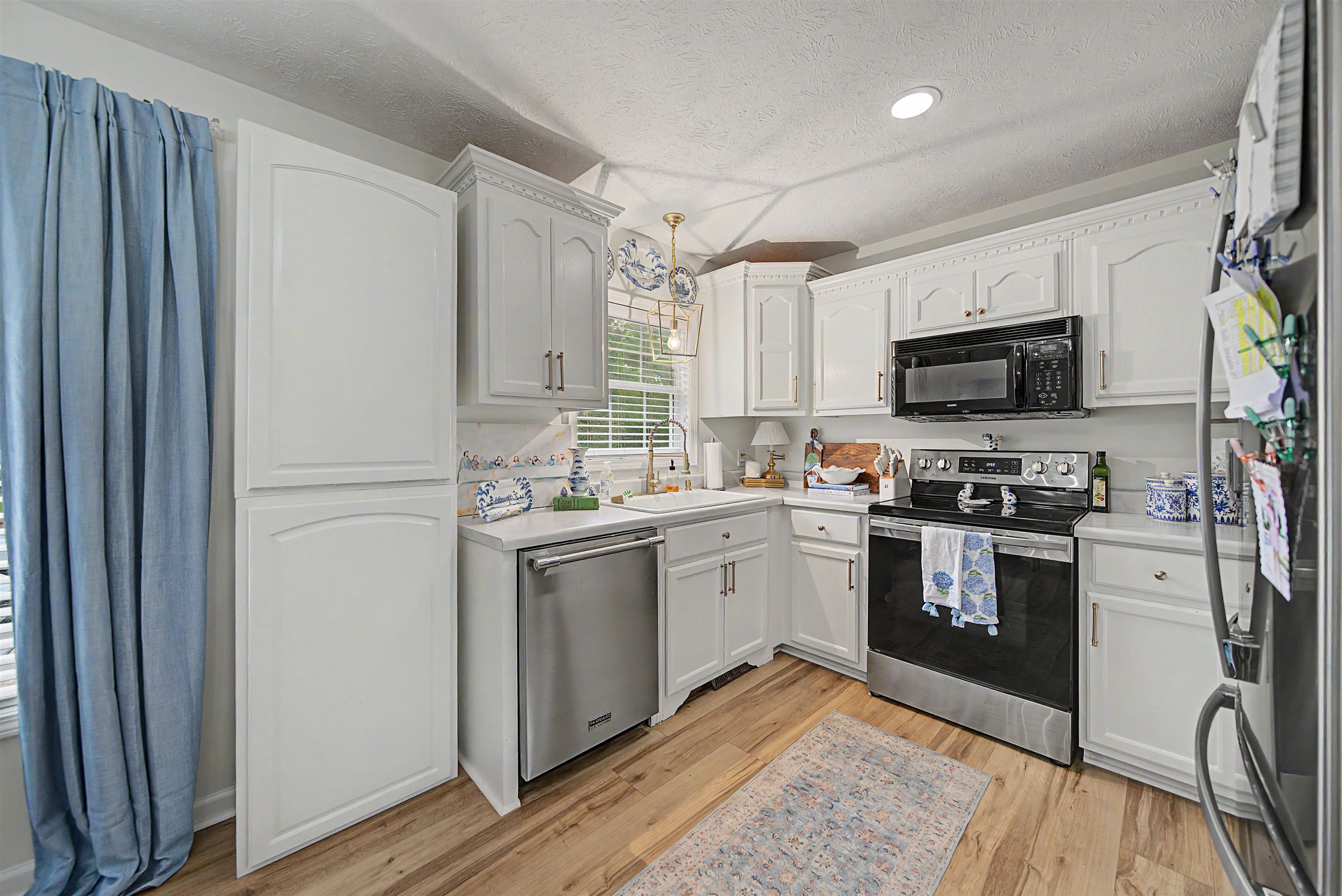 18 Eric Lane Ramer, TN 38367 - Photo 17 of 25 a kitchen with stainless steel appliances granite countertop a refrigerator a stove top oven a sink and dishwasher