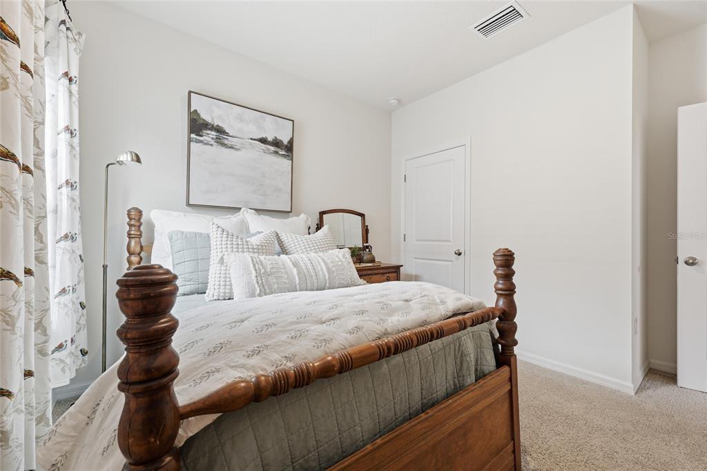 8261 Southwest 60th Avenue Gainesville, FL 32608 - Photo 13 of 34 a bedroom with a bed and a painting on the wall